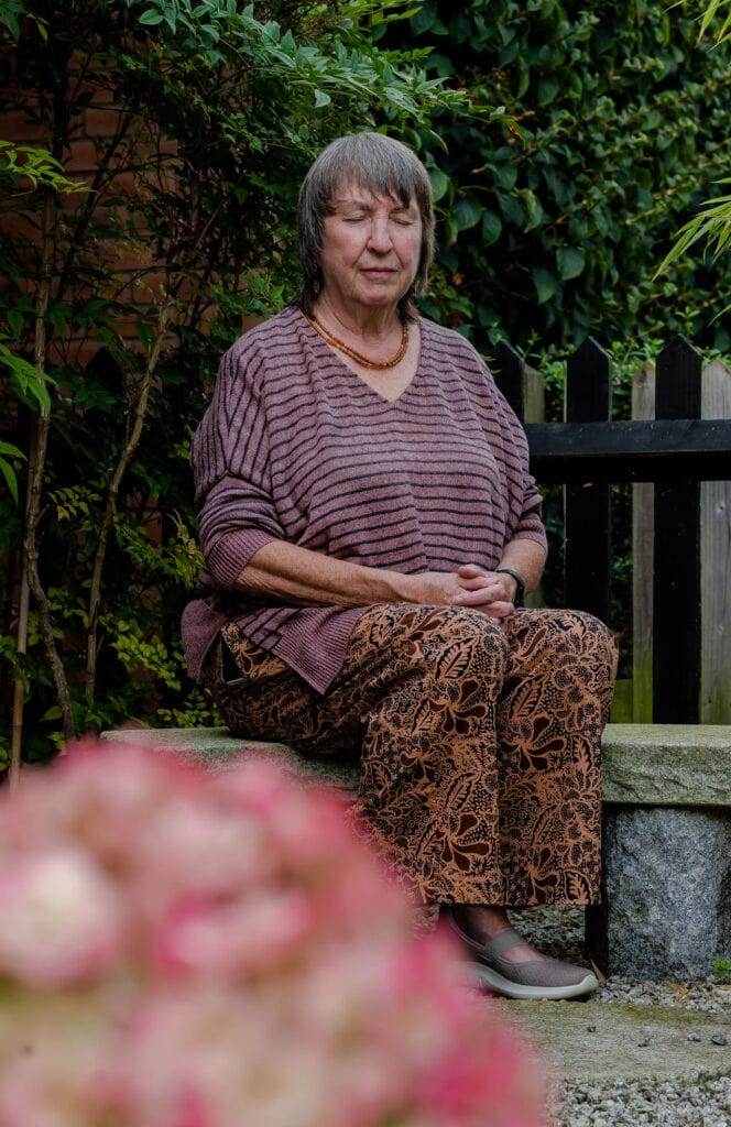Sue Meditating in a Japanese garden