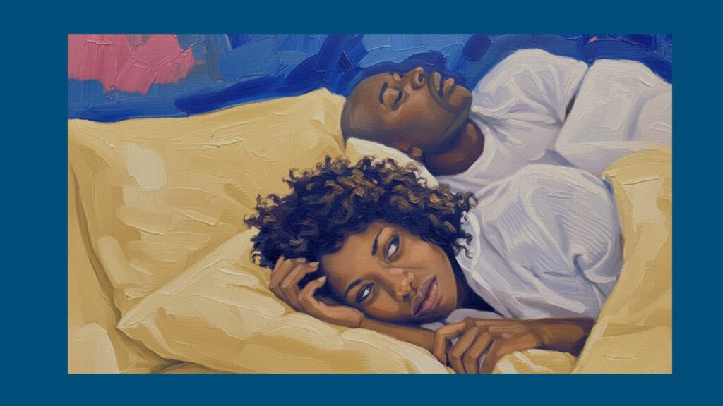 Woman lying awake in bed while her partner snores, showing how snoring can disturb sleep at night. One thing that can lead to sleep divorce.