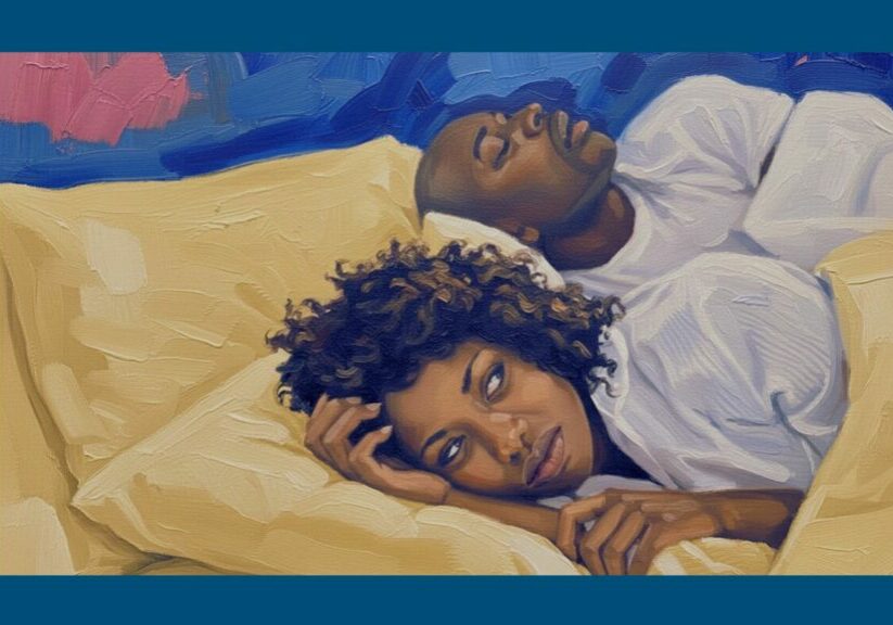 Woman lying awake in bed while her partner snores, showing how snoring can disturb sleep at night. One thing that can lead to sleep divorce.
